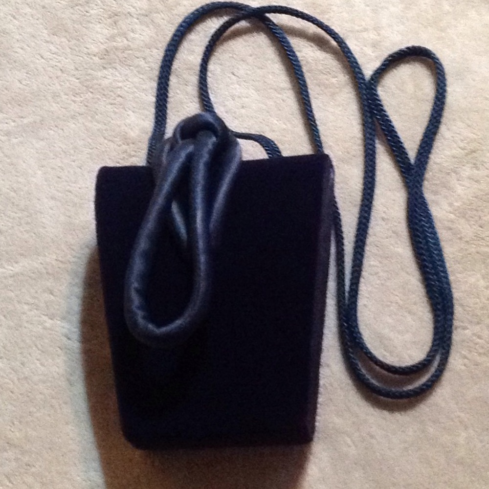 Navy blue velvet and satin bag with knot closure.